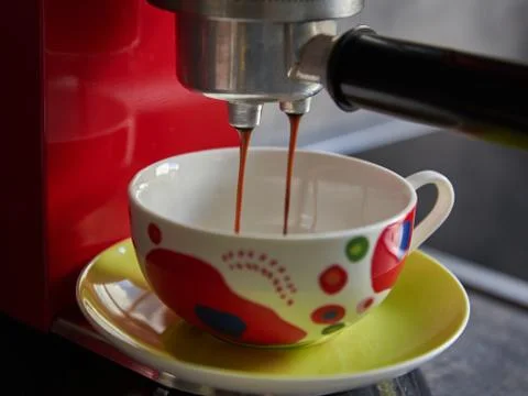 Brewing coffee with a coffee machine. Closeup of a coffee machine. Closeup of Stock Photos