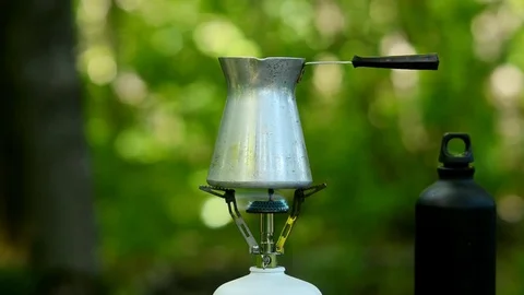Brewing coffee in a green forest. Stock Footage 77972693
