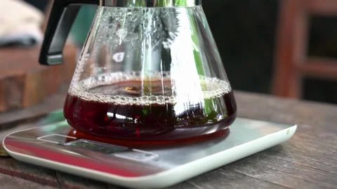 Brewing coffee jar close up from coffee maker hand fresh morning routine in 4k Stock-Footage 336585307
