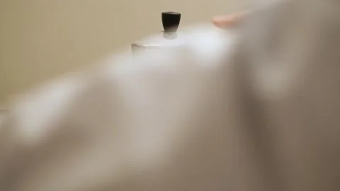 Brewing coffee in a moka pot before work Stock Footage 240144009