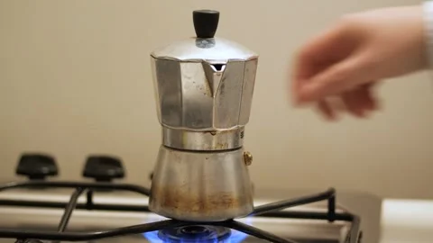 Brewing coffee in a moka pot before work Stock Footage 240144015