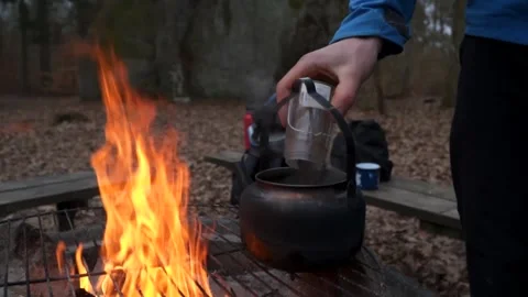 Brewing coffee over camp fire Stock Footage 149521057