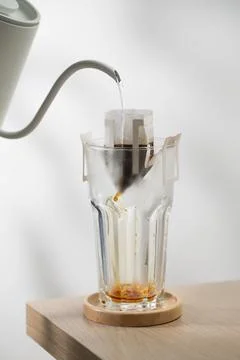 Brewing coffee through pre-made paper filters. Stock Photos