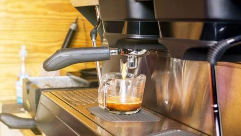 Brewing a coffee using a coffee machine in a coffee shop. Stock Photos