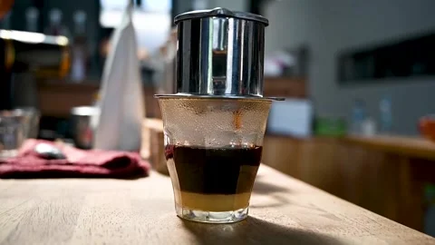 Brewing coffee using a Vietnamese Traditional Coffee Stock Footage 230350556