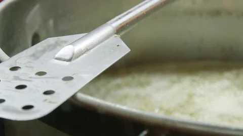 Brewing Craft Beer in Large Brew Kettle with Silver Brew Paddle at Brewery Stock Footage 75248704