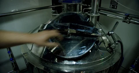 Brewing dark Brewer opens the hatch with Beer in the tank for brewing, process Stock Footage 129525042