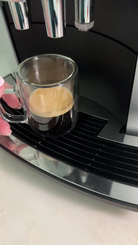 Brewing espresso: closeup sequence from machine to perfect shot in glass cup Stock Footage 320851422