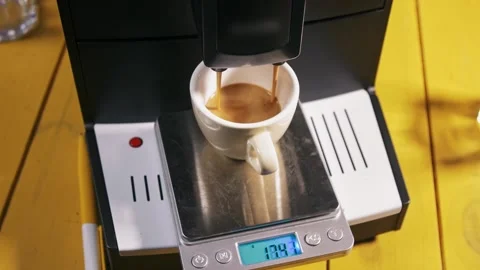 Brewing espresso on scales - Automatic coffee machine Stock Footage 160160183