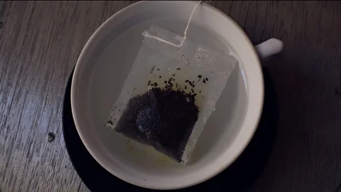 Brewing fresh mate tea on a white porcelain cup and hot boiling water Stock Footage 76811463