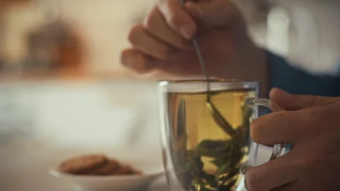 Brewing herbal tea with mint leaves in a cozy kitchen setting Stock Footage 323731163