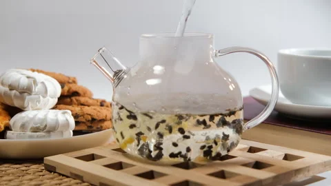 Brewing loose leaf tea with lemon and snacks Stock Footage 317296047