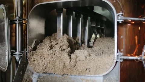 Brewing. Mixing of malt in the brewing tank. Used malt after brewing process. Stock Footage 134680827