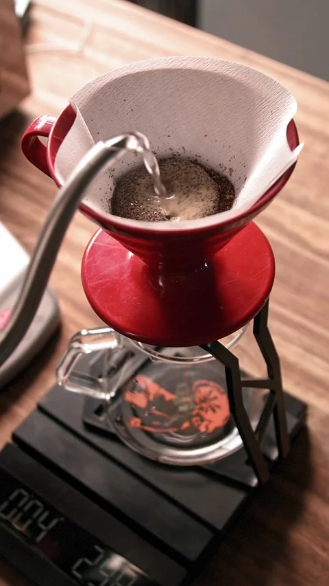 Brewing Pour Over Coffee in red plastic V60 with Gooseneck kettle Stock Footage 234216937