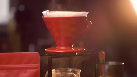 Brewing Pour over filter coffee - drips from ceramic brewer in slow motion Stockbeeldmateriaal 146799724