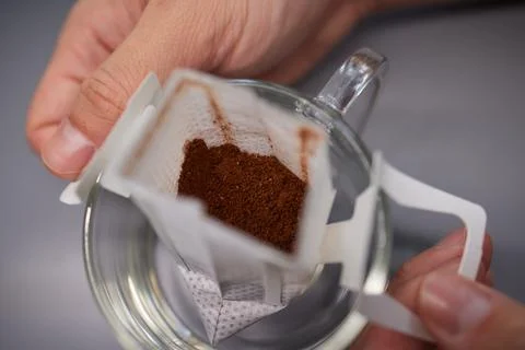 Brewing process,a bag filled with boiling water for drip coffee in a cup,top Stock Photos