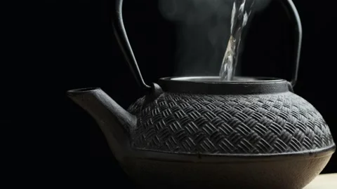 Brewing tea in cast iron tea pot, 2 shots - pouring hot water and putting a lid 스톡 동영상 144367210