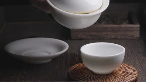 Brewing tea closeup, tea water is poured into a cup Stock Footage 234509959
