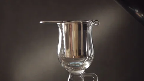 Brewing tea in a glass Cup using a metal strainer. Hot water from the kettle Stock Footage 107884178