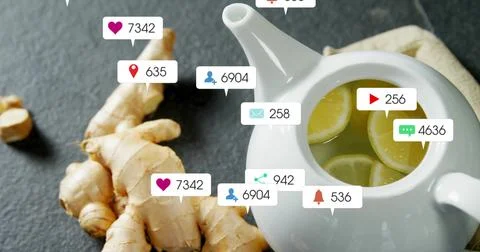 Brewing tea with lemon slices in ceramic teapot on slate counter, ginger, social Stock Photos