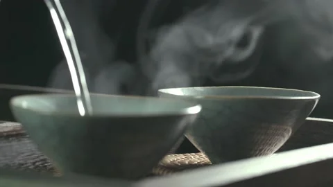 Brewing tea, pouring tea, tea, water column hot air close-up Stock Footage 234496458