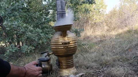 Brewing tea in samovar in nature_4K Stock Footage 126906336