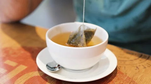 Brewing tea with a tea bag in white cup. Stock Footage 287995825