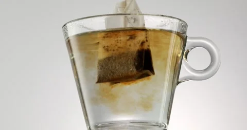 Brewing tea in a transparent mug using a tea bag Stock Footage 244131946