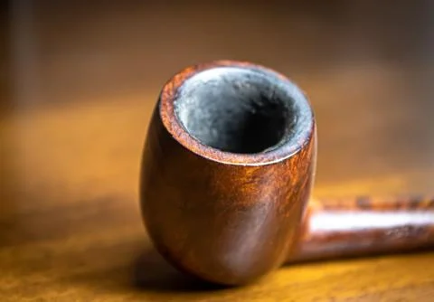 Briar smoking pipe on the table, focus on the bowl Stock Photos