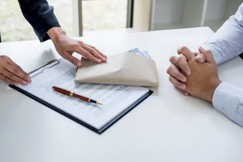 Bribery and corruption concept, bribe in the form of dollar bills, Businessma Stock Photos