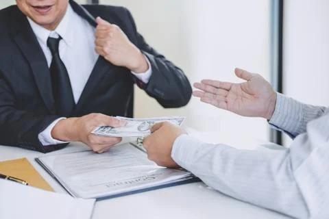 Bribery and corruption concept, bribe in the form of dollar bills, Businessma Stock-Fotos