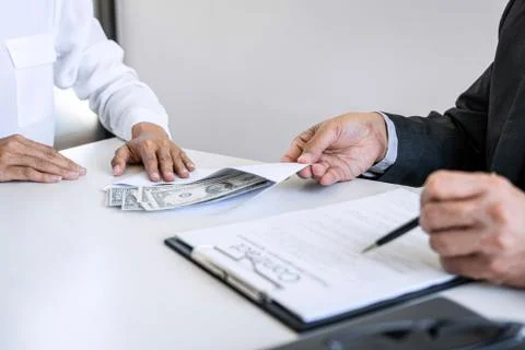Bribery and corruption concept, bribe in the form of dollar bills, Businesswo Stock Photos