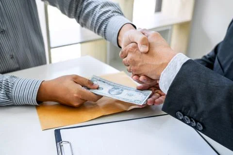 Bribery and corruption concept, bribe in the form of dollar bills, Businessma Stock Photos