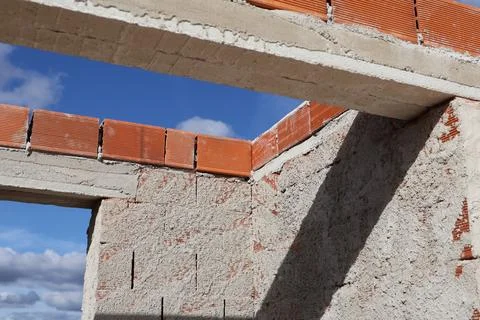 Brick and concrete construction with blue sky background Stock Photos