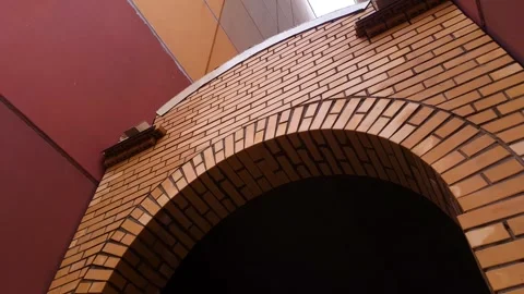 Brick arch. Brick masonry semicircular aisle. Video stock 304626960