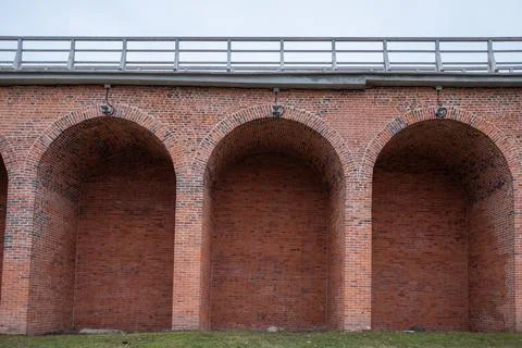 The brick archway is empty and has a very old look to it Stock Photos