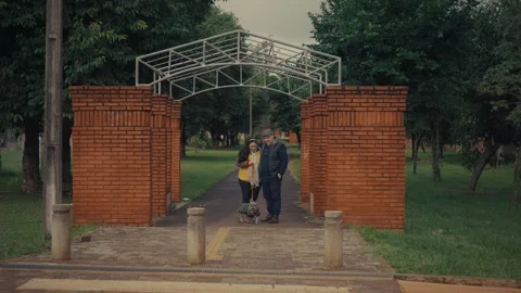 Brick archway with metal frame frames a park entrance Stock Footage 337862396