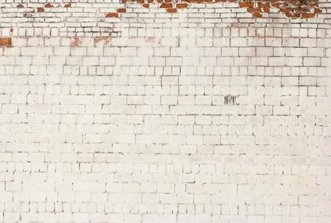 Brick background, the wall of an old brick building painted white with elemen Foto stock