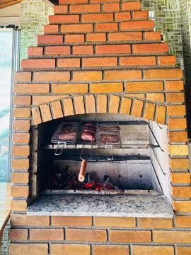 Brick barbecue in a kitchen Stock Photos