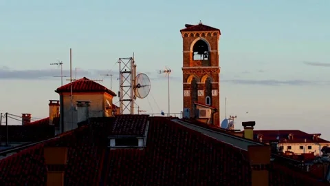 A brick bell tower rises above the rooftops in venice, italy Stock Footage 312677493