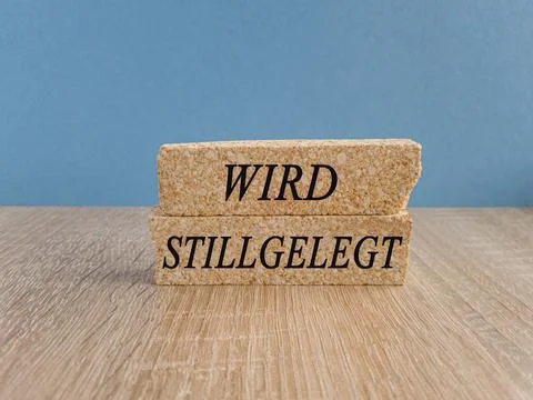 Brick blocks with the German text Wird stillgelegt (Will be decommissioned) Stock Photos