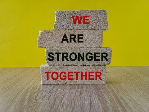 Brick blocks with red words we are stronger together. Stock Photos