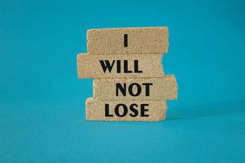 Brick blocks with text I will not lose. Beautiful blue background Stock Photos