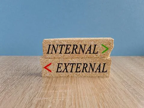 Brick blocks with two opposite arrows over blue background. Stock Photos