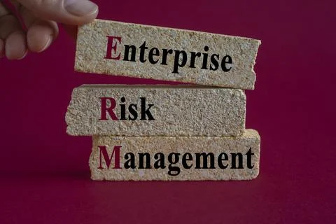Brick blocks with words Enterprise Risk Management. Businessman hand. Stock Photos