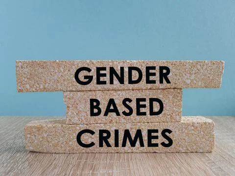 Brick blocks with words GENDER BASED CRIMES. Beautiful blue background Foto stock