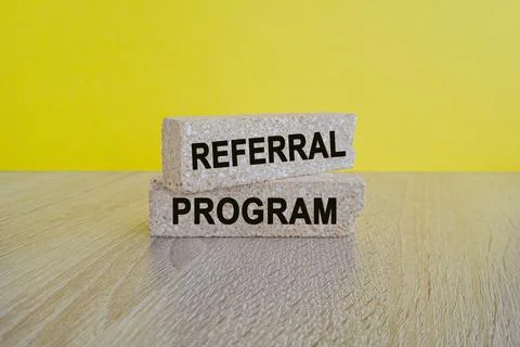 Brick blocks with words REFERRAL PROGRAM. Beautiful yellow background 스톡 사진