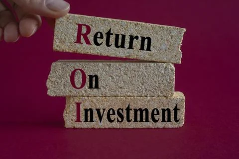 Brick blocks with words ROI return on Investment on beautiful red background. Stock Photos