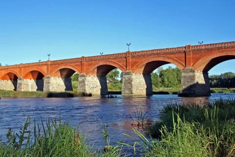 Brick bridge across river Venta in Kuldiga, Latvia Stock Photos