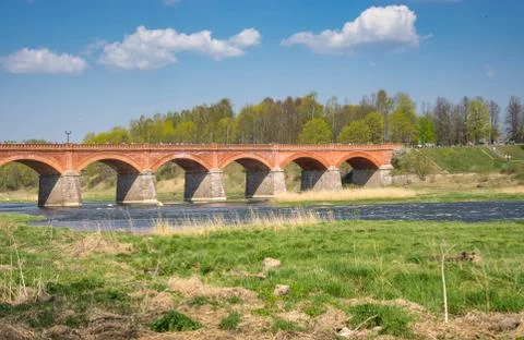 Brick bridge across the Venta River in the city of Kuldiga in Latvia. Stock Photos
